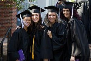 HSU students in cap and gown standing in line at graduation